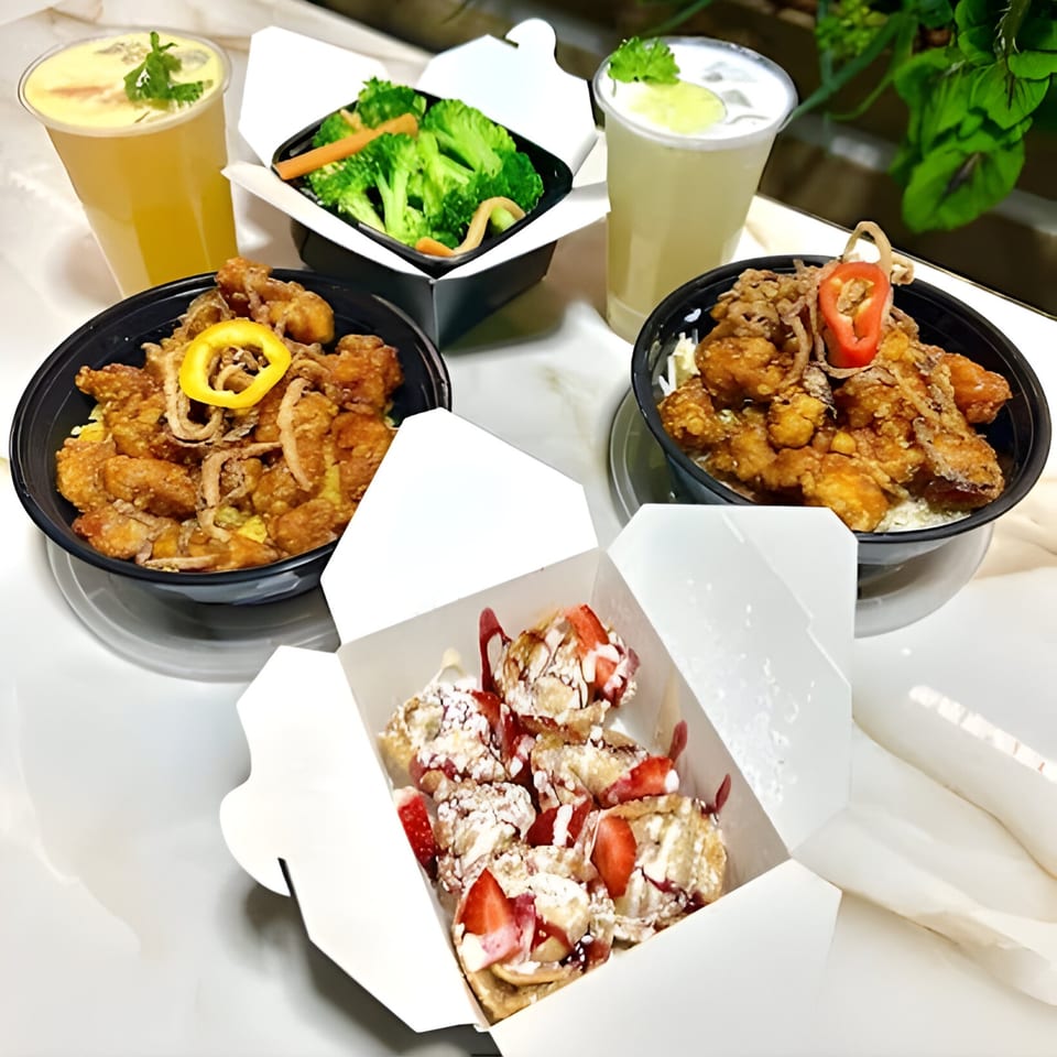 Two Bobby Wong's chicken bowls, a side of broccoli, two drinks, and strawberry dessert in takeout containers.